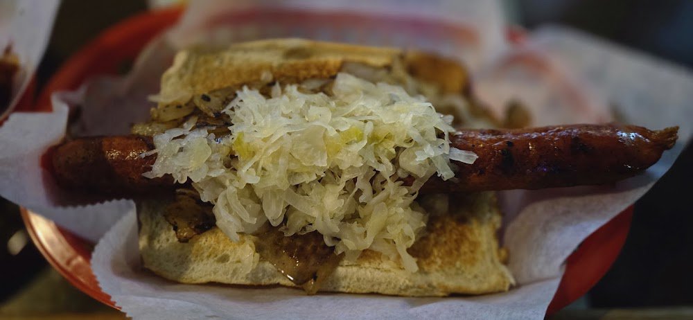 Sausage on a roll with sauerkraut